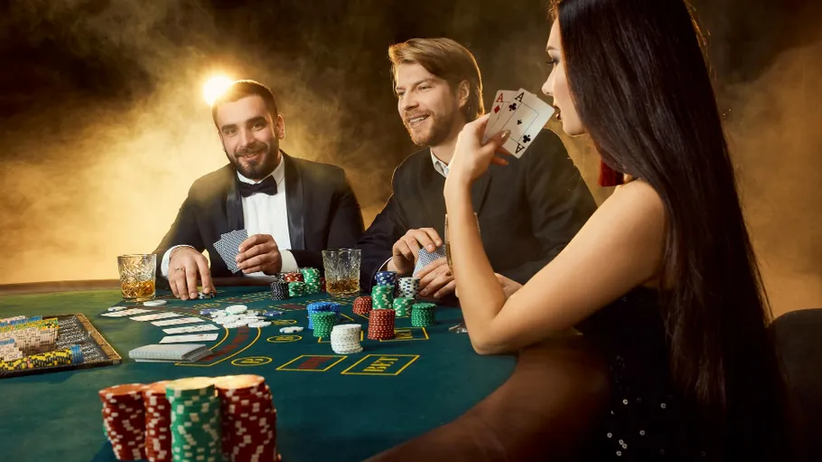 Three people playing poker in a casino.