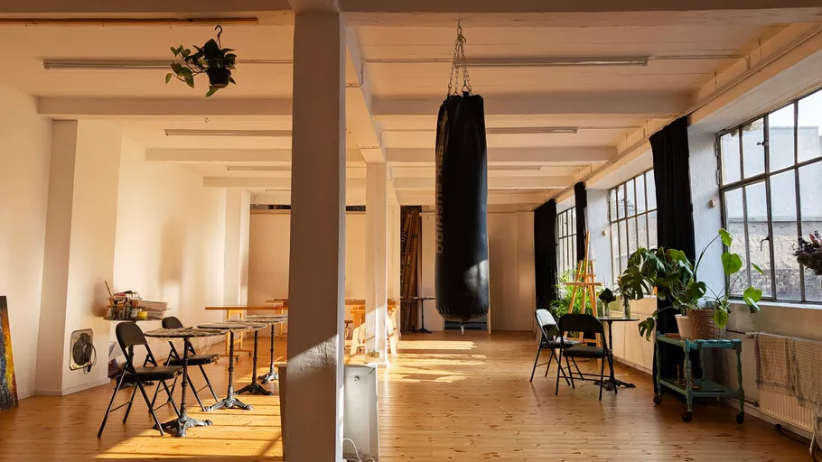 Spacious loft with punching bag and chairs.