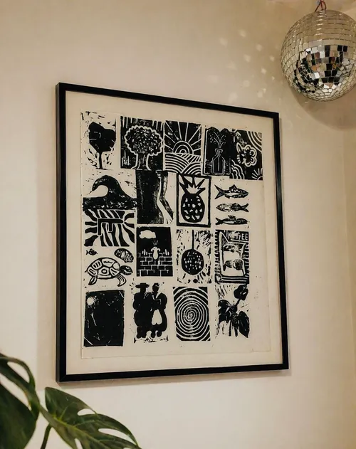 Framed black-and-white art with various symbols.