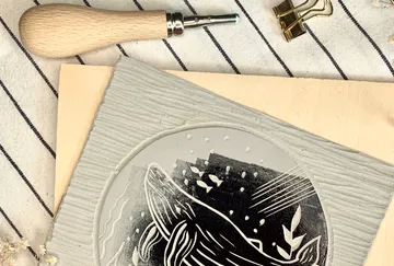 Carving tool and whale print on striped fabric.