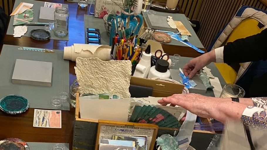 Craft table with various art supplies.