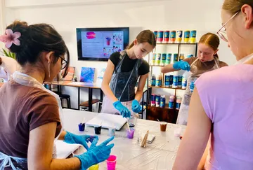 People crafting with paint in art studio.