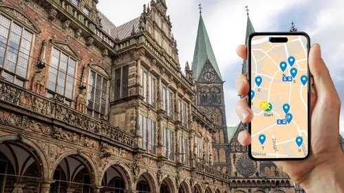 Hand holding phone with map, historic building.