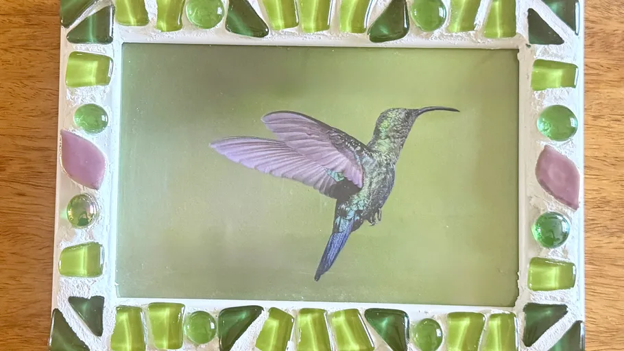 Hummingbird image framed with colorful mosaic.
