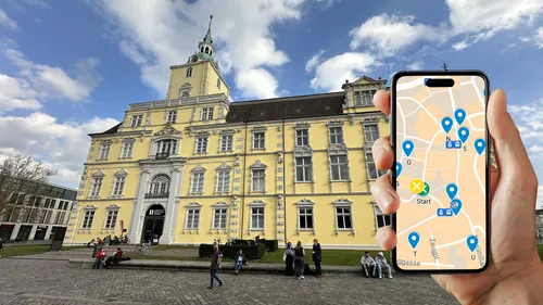 Hand holding phone with map, historic building.