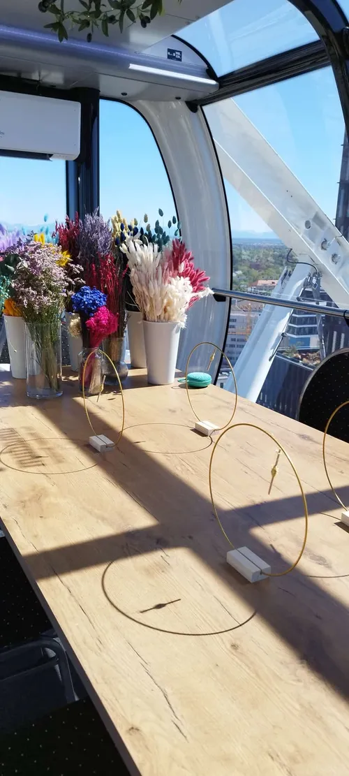 Vases of colorful flowers on a wooden table.