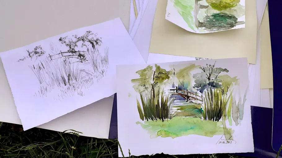 Art sketches of landscapes on paper outdoors.