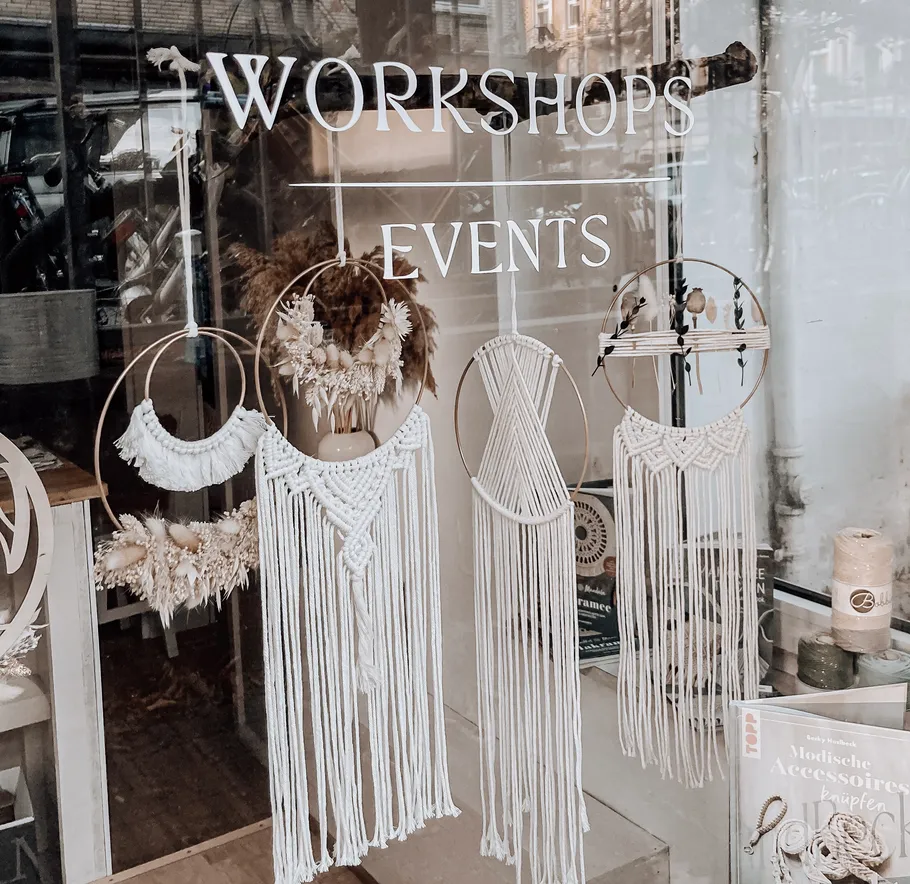 Macramé decorations displayed in shop window.