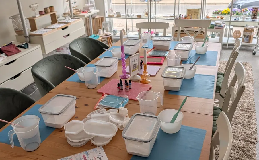 Craft setup on table, containers and tools.