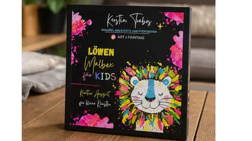 Bunte Löwen-Malbox für Kinder auf Tisch.
