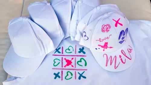 Decorated caps with customized art on table.