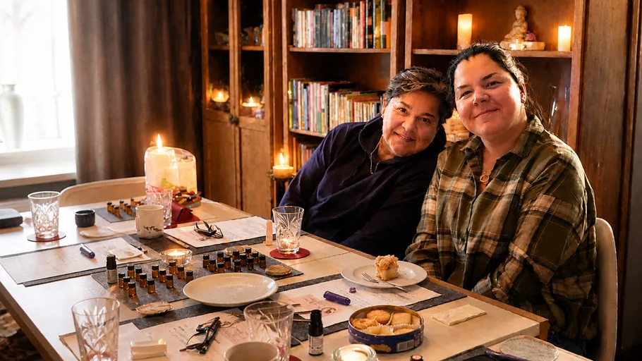 Two women smiling at a table with candles.