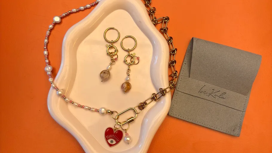 Jewelry set on a decorative plate.