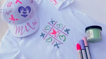 Decorated cap and shirt with colorful markers.