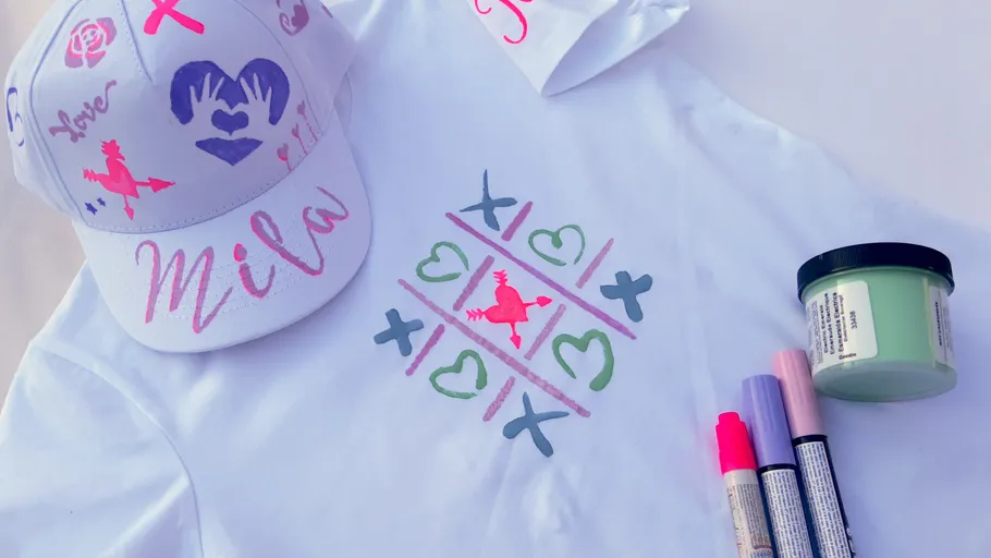 Decorated cap and shirt with colorful markers.