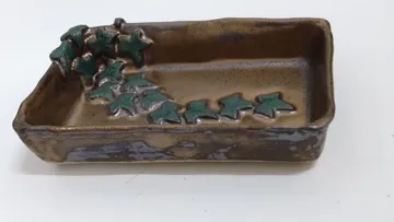 Rectangular ceramic dish with leaf designs.