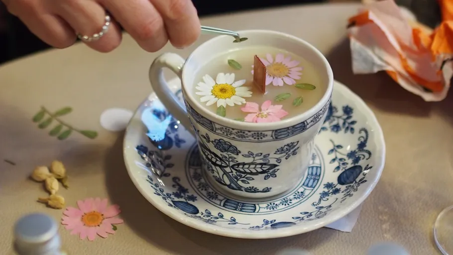 Flower-decorated tea cup on a table.