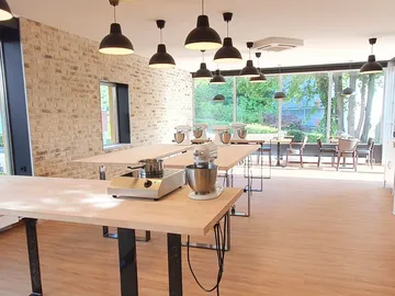 Kitchen workstations with appliances in a bright room.