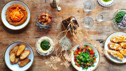 Assorted dishes on rustic wooden table.