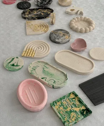 Colorful resin trays on a patterned table.