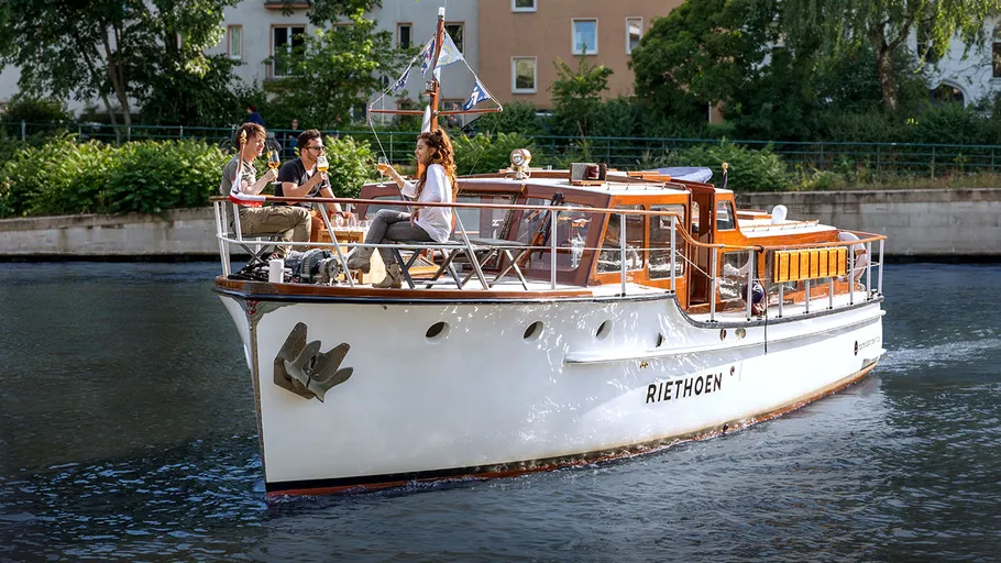 Group enjoying on a boat in a canal.