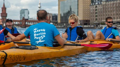 People kayaking on a river in Berlin.