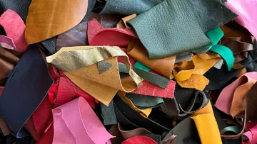 Colorful leather scraps piled together closely.