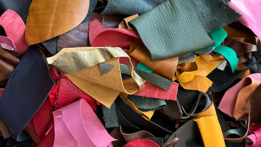 Colorful leather scraps piled together closely.