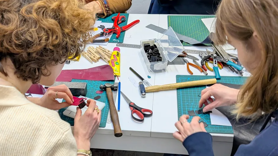 People crafting with tools on a table.