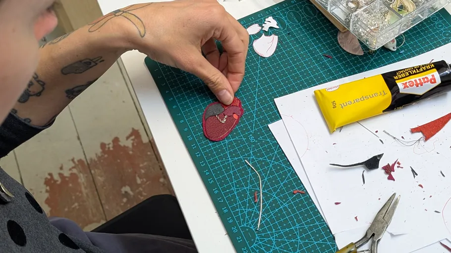 Person crafting on a cutting mat table.