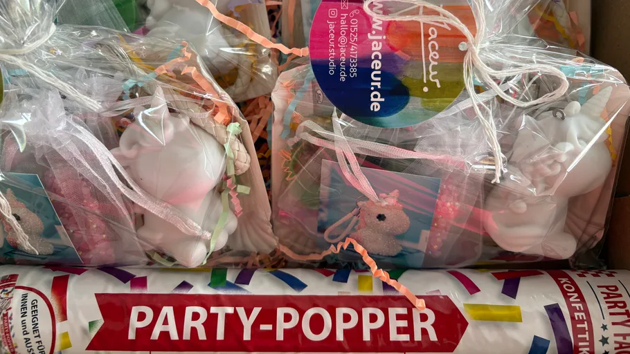 Party popper and unicorn gifts in packaging.
