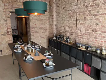 A long table is covered with dishes and bottles.