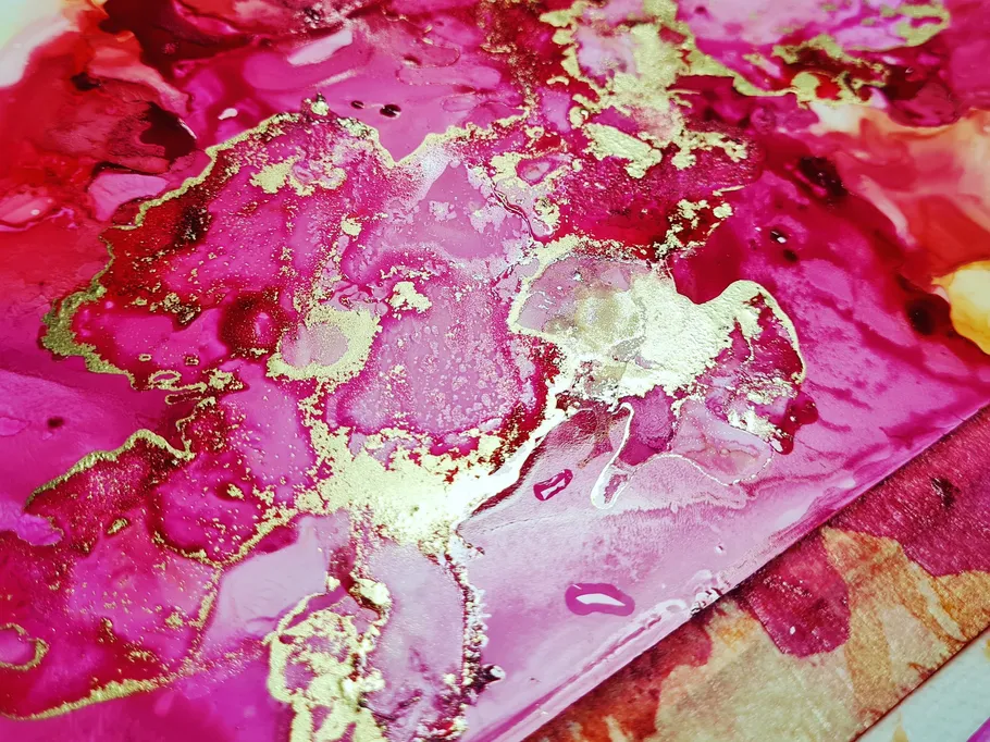 Vibrant pink and gold abstract artwork.