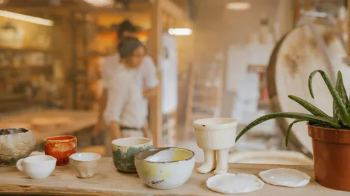Ceramic bowls on shelf in pottery studio.