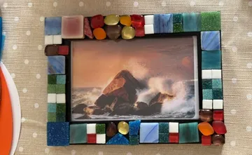 Mosaic photo frame with ocean wave picture.