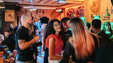 People socializing in a lively bar setting.