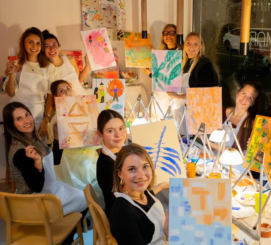 Group of women painting in a cozy room.