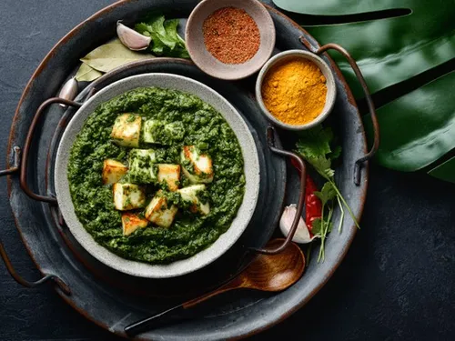 Green dish with cubes of cheese on a tray.