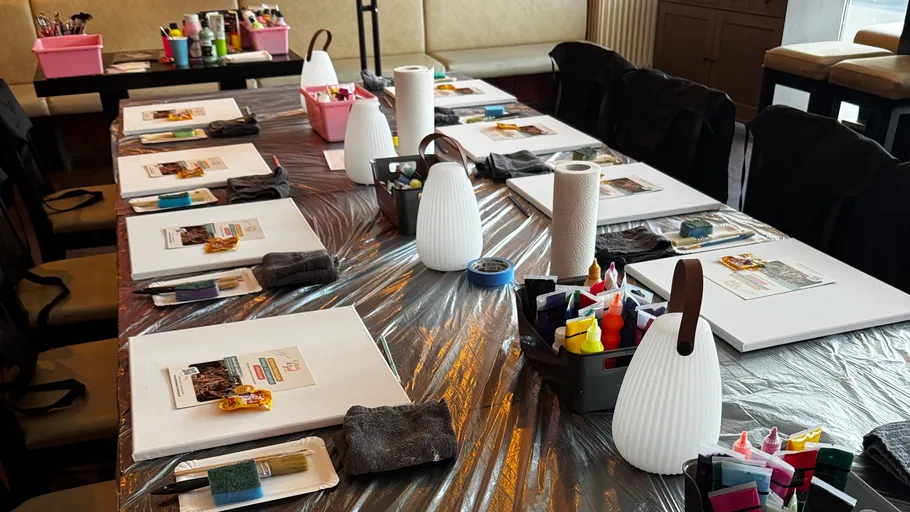 Art supplies arranged on a covered table.