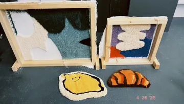 Colorful hand-tufted rugs on wooden frames.