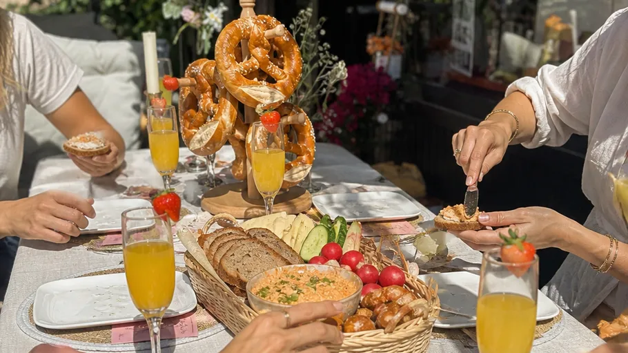 People enjoying brunch with pretzels outside.