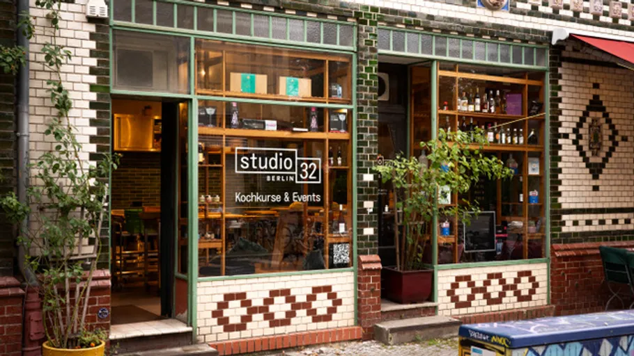 Shop window with 'studio32' signage, urban setting.