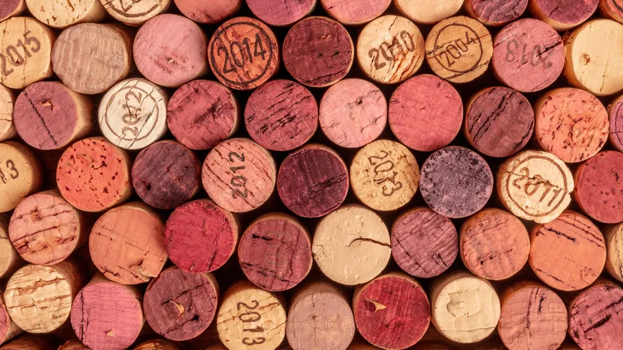 Wine corks stacked with visible vintage years.