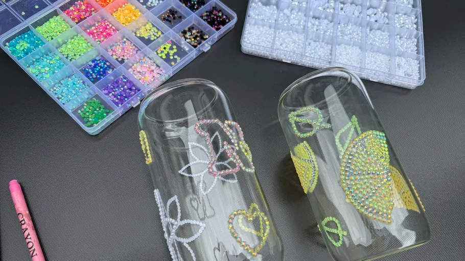 Two decorated glasses with various colored beads.