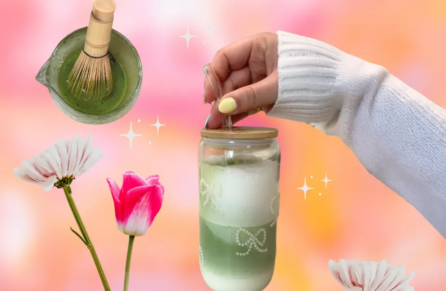 Hand holding matcha drink with flowers around.
