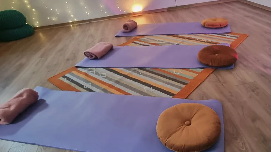 Yoga mats with cushions and rolled towels.