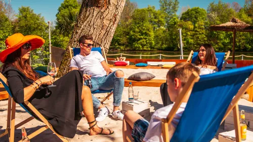 Group relaxing in deck chairs outdoors.