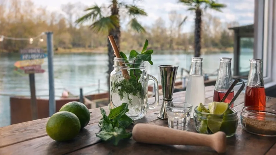 Mojito ingredients on table with river view.