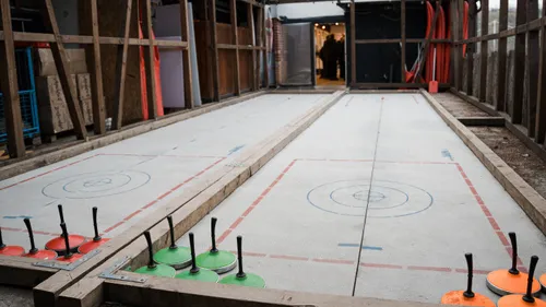 Ice stock rink with equipment in construction area.