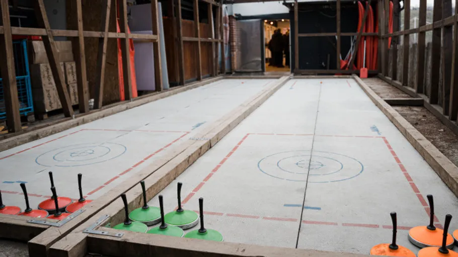 Ice stock rink with equipment in construction area.